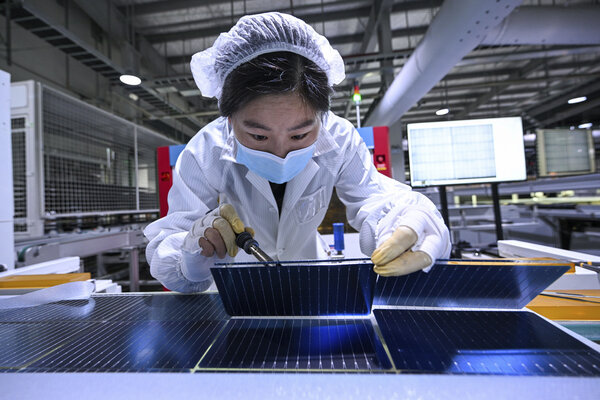 A woman works on the production line of solar panels at a factory in Sihong county in east China's Jiangsu province Thursday, Jan. 23, 2025. The state of California is courting China, and others, in hopes of making trade deals that insulate it from Trump administration tariffs.